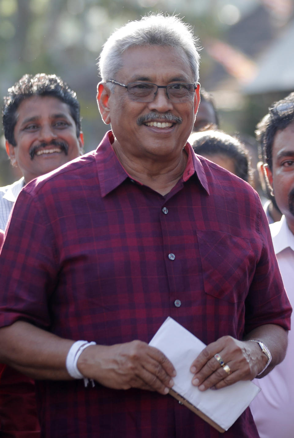 Sri Lanka's former Defense Secretary and presidential candidate Gotabaya Rajapaksa leaves a polling station after casting his vote in Embuldeniya, on the outskirts of Colombo, Sri Lanka, Saturday, Nov. 16, 2019. Polls opened in Sri Lanka’s presidential election Saturday after weeks of campaigning that largely focused on national security and religious extremism in the backdrop of the deadly Islamic State-inspired suicide bomb attacks on Easter Sunday. (AP Photo/Eranga Jayawardena)