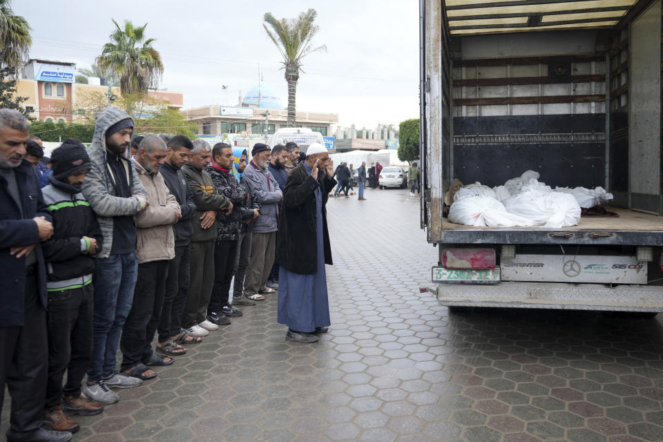 Palestinians pray for the relatives killed in the Israeli bombing of the Nusseirat refugee camp in the Gaza Strip at Al Aqsa Hospital in Deir al Balah on Thursday, Feb. 15, 2024. (AP Photo/Adel Hana)