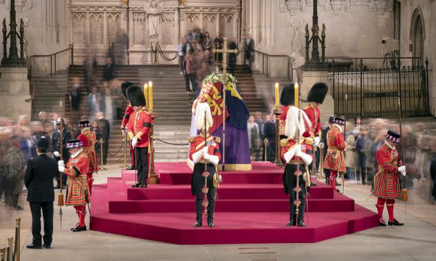 Members of the public as they file past the coffin of Queen Elizabeth II, draped in the Royal Standard with the Imperial State Crown and the Sovereign's orb and sceptre, lying in state on the catafalque in Westminster Hall, at the Palace of Westminster, London, ahead of her funeral on Monday. (Photo: Danny Lawson via PA Wire/PA Images)