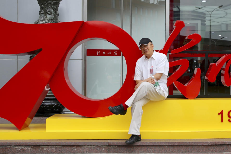 In this photo provided by the Dong family, Dong Yuyu poses for a photo in Beijing in June 2019. A veteran Chinese journalist who worked at a ruling Communist Party-affiliated newspaper and was a Harvard University fellow faces espionage charges after he was detained while meeting with a Japanese diplomat in a restaurant, his family said Monday, April . (Dong Family via AP)