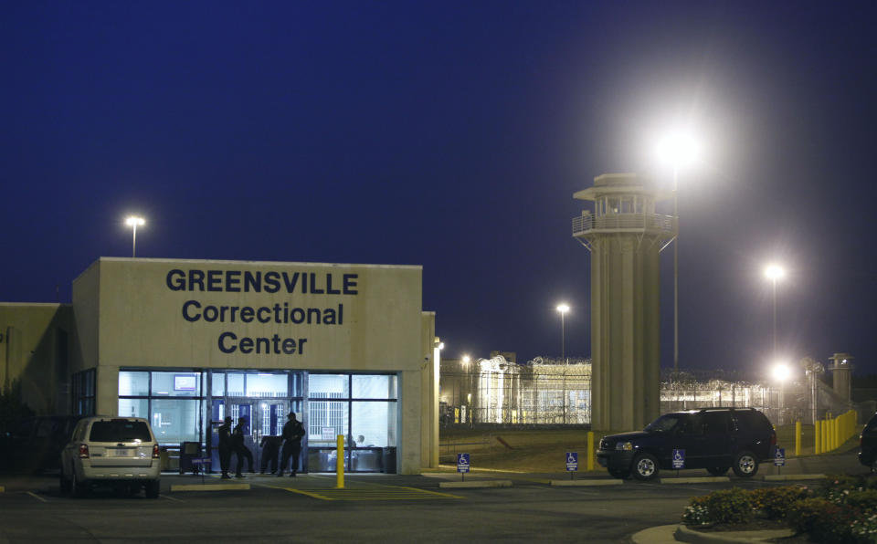 FILE - In this Sept. 23, 2010 file photo prison guards stand outside the entrance to the Greensville Correctional Center, where executions are carried out, in Jarratt, Va. Death penalty opponents are cautiously optimistic they have enough bipartisan support from lawmakers to pass a bill in 2021 ending executions in Virginia. Democratic Sen. Scott Surovell is again sponsoring a bill that would abolish the death penalty, and he has a Republican chief co-patron. (AP Photo/Steve Helber, File)