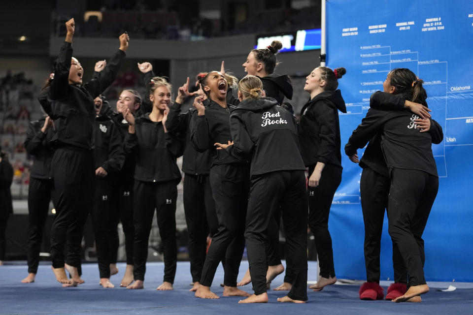 Utah celebrates after achieving the highest score in the second session of the semifinals of the NCAA women's gymnastics championships, Thursday, April 13, 2023, in Fort Worth, Texas. (AP Photo/Tony Gutierrez)