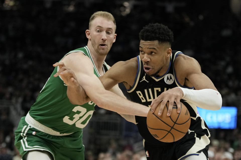 Milwaukee Bucks' Giannis Antetokounmpo gets past Boston Celtics' Sam Hauser during the second half of an NBA basketball game Tuesday, April 9, 2024, in Milwaukee. The Bucks won 104-91. (AP Photo/Morry Gash)