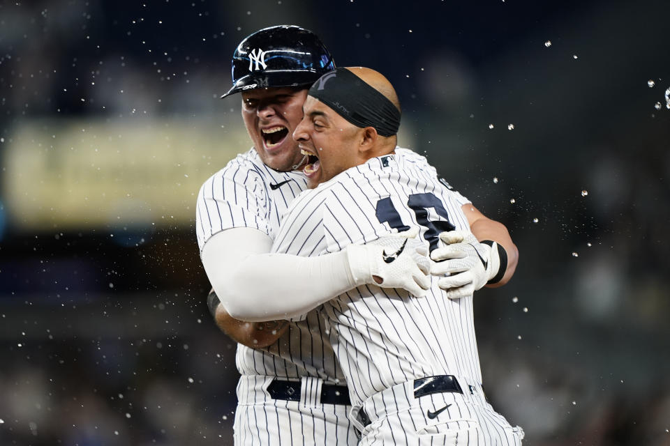 New York Yankees Luke Voit celebrates with Yankees Rougned Odor after hitting a ninth-inning, walk-off RBI single to defeat the Kansas City Royals 6-5 in a baseball game, Wednesday, June 23, 2021, at Yankee Stadium in New York. (AP Photo/Kathy Willens)