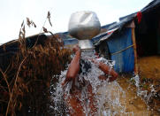 <p>A Rohingya refugee takes a bath outside his temporary shelter at Balukhali makeshift refugee camp in Cox’s Bazar, Bangladesh, Sept. 13, 2017. (Photo: Danish Siddiqui/Reuters) </p>