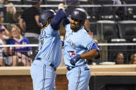 Toronto Blue Jays' Marcus Semien and Vladimir Guerrero Jr. (27) celebrate after scoring on a three-run home run by Semien during the fifth inning of the team's baseball game against the New York Mets, Saturday, July 24, 2021, in New York. (AP Photo/Mary Altaffer)