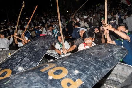 Muslim hardline protesters clash with anti-riot policemen during a protest against Jakarta's incumbent governor Basuki (Ahok) Tjahaja Purnama, an ethnic Chinese Christian running in the upcoming election, in Jakarta, Indonesia, November 4, 2016 in this picture taken by Antara Foto. Antara Foto/M Agung Rajasa/via REUTERS