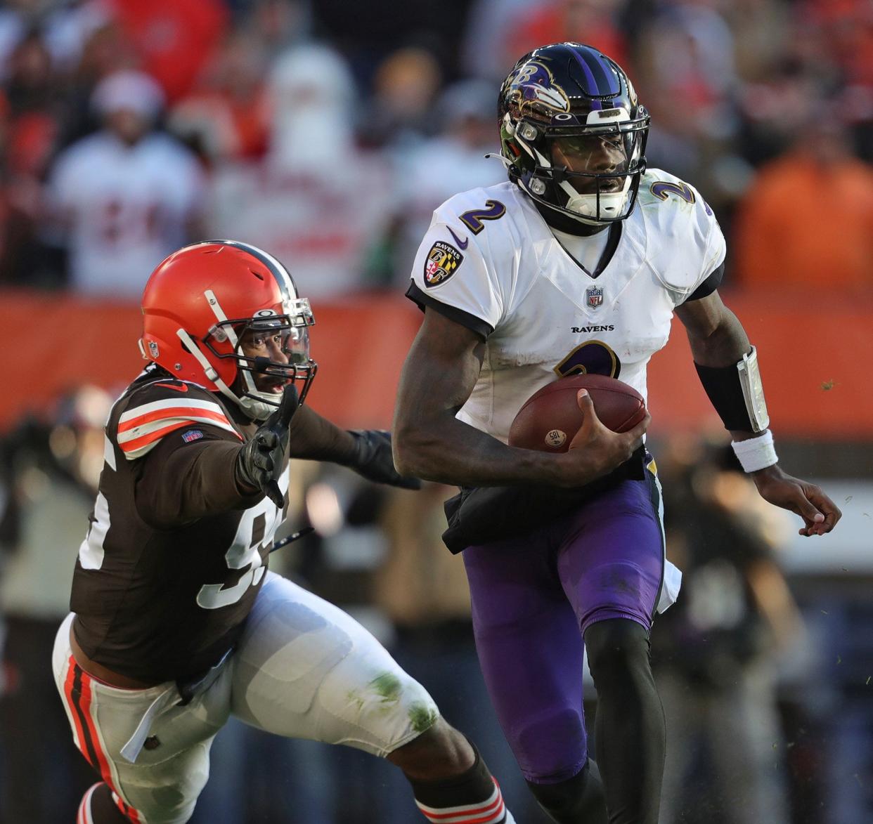 Baltimore Ravens quarterback Tyler Huntley (2) slips away from Cleveland Browns defensive end Myles Garrett (95) on Dec. 12, 2021, in Cleveland.