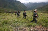 <p>Members of the 51st Front of the Revolutionary Armed Forces of Colombia (FARC) patrol in the remote mountains of Colombia, August 16, 2016. Picture taken August 16, 2016. (John Vizcaino/Reuters) </p>