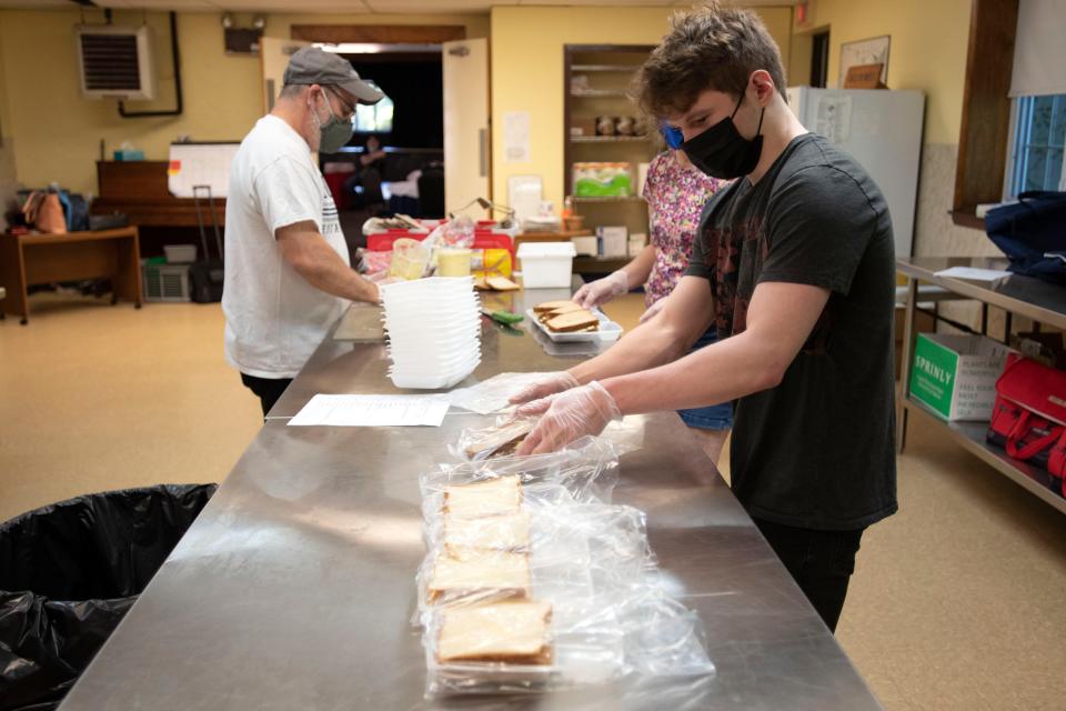 Guy Wilde, from left, Maria Wilde and Luke Brown help prepare food for Meals on Wheels at Central Bucks Senior Center in Doylestown on Tuesday, July 5, 2022. 