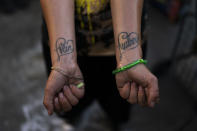 Jennifer Catano, a 27-year-old fentanyl addict, shows tattoos of the names of her two children, Evan and Audrey, in Los Angeles, Tuesday, Aug. 23, 2022. "My mom doesn't think it's a good idea because she thinks it's gonna hurt the kids because I'm not ready to get rehabilitated," said Catano who hasn't seen them for several years. (AP Photo/Jae C. Hong)