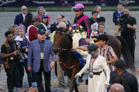 Bruce Lunsford, third from left, owner of the horse Art Collector, stands in the winner's circle with jockey Junior Alvarado after Art Collector won the Pegasus World Cup Invitational horse race, Saturday, Jan. 28, 2023, at Gulfstream Park in Hallandale Beach, Fla. (AP Photo/Lynne Sladky)