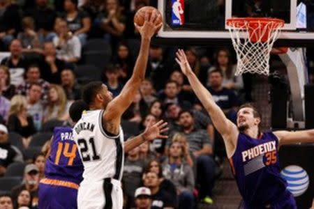 San Antonio Spurs power forward Tim Duncan (21) shoots the ball over Phoenix Suns power forward Mirza Teletovic (35) during the second half at AT&T Center. Mandatory Credit: Soobum Im-USA TODAY Sports