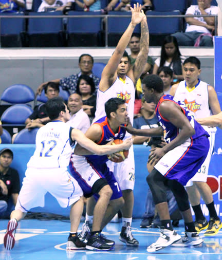 Air21's Nonoy Baclao is double-teamed by TNT's Rabeh Al-Hussaini and Larry Fonacier. (PBA Images)