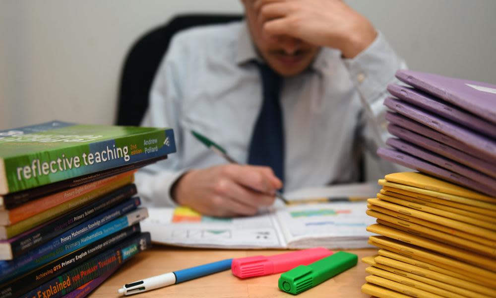 A teacher marks homework.