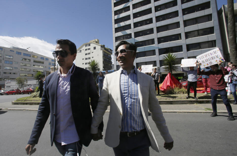 FILE - In this June 4, 2019 file photo, Ecuadorian gay couple Javier Benalcazar, left, and Efrain Soria arrive to the Constitutional Court to hear the final decision on same sex marriage, before the decision was rescheduled by the court for a future date, in Quito, Ecuador. "If our marriage is approved we will be happy, and it will be our reward. If not, we will continue to fight." Soria said. On Wednesday, June 12, 2019, Ecuador joined a half-dozen nations in Latin America formally recognize same-sex marriage. (AP Photo/Dolores Ochoa, File)