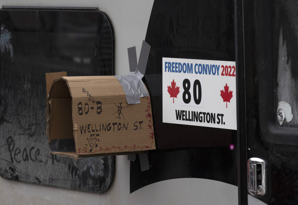 A cardboard mailbox is taped to the side of a camper being used in protests against COVI-19 mandates, Wednesday, Feb. 16, 2022 in Ottawa. Trucks in Canada that have been clogging crossings at the U.S. border for more than two weeks have abandoned all but one of their blockades. Canadian authorities say they're confident that protesters at the crossing in Manitoba will be gone by Wednesday.(Adrian Wyld/The Canadian Press via AP)