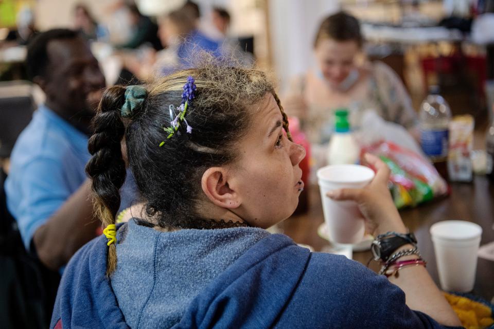 Alecia Dalton wears a flower in her hair as she eats dinner at Trinity March 31, 2022.