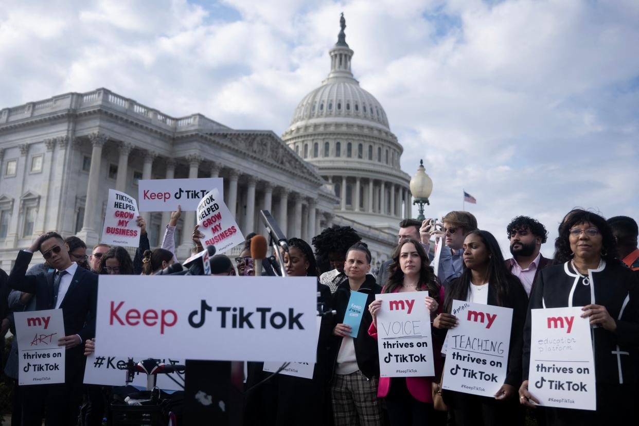 People gather for a press conference about their opposition to a TikTok ban