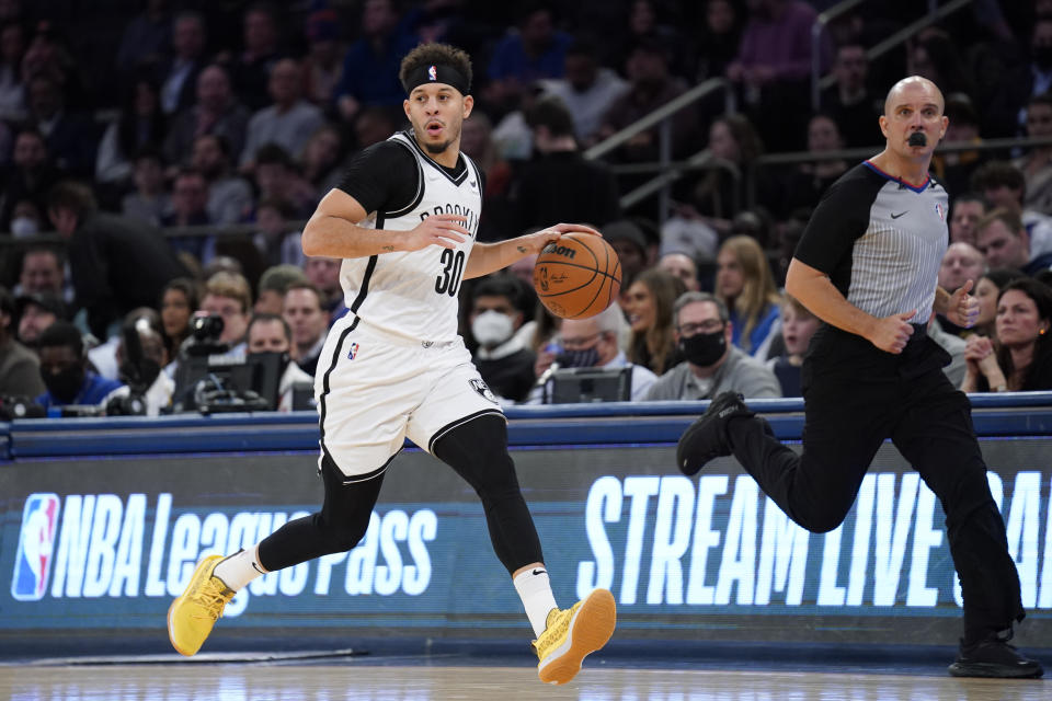 Brooklyn Nets guard Seth Curry dribbles up the court during the first half of an NBA basketball game against the New York Knicks, Wednesday, Feb. 16, 2022, in New York. (AP Photo/John Minchillo)