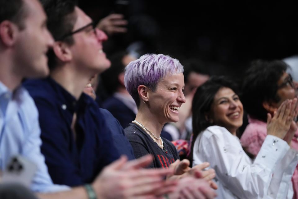 Megan Rapinoe reacts as fans cheer for her during the first half of an NBA basketball game between the Brooklyn Nets and the Houston Rockets, Wednesday, March 29, 2023, in New York. (AP Photo/Frank Franklin II)