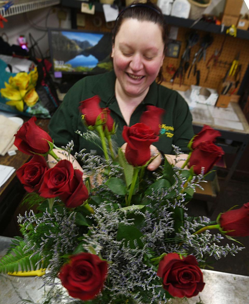 Taylor Rinbolt, assistant manager at McKenna's Flowers & Plants, prepares a Mother's Day rose arraignment Monday at the Norwich business. She will soon be a mother for the first time with a due date of May 19.