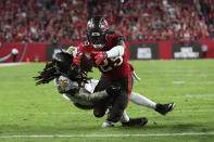 Tampa Bay Buccaneers running back Rachaad White (29) dives into the end zone for a touchdown as New Orleans Saints linebacker Demario Davis (56) covers late in the second half of an NFL football game in Tampa, Fla., Monday, Dec. 5, 2022. The Buccaneers won 17-16. (AP Photo/Mark LoMoglio)
