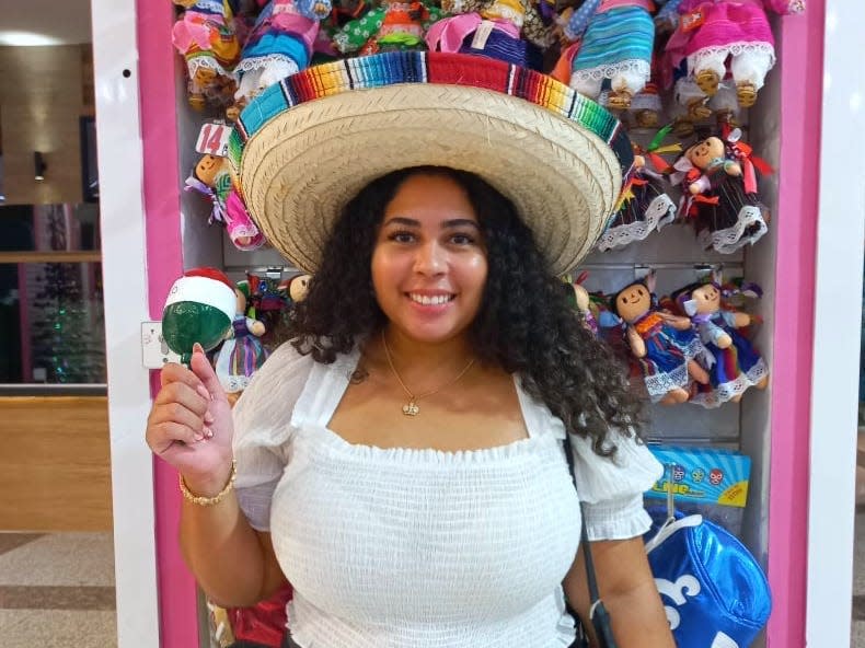 Melissa in a sombrero holding a maracha.