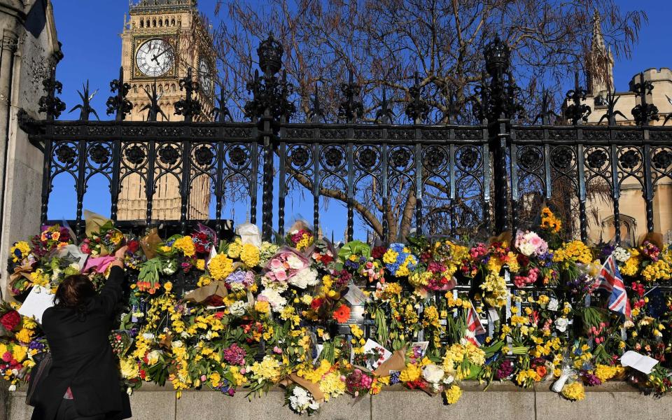 It comes as wellwisher laid flowers outside the Houses of Parliament - Credit: CHRIS J RATCLIFFE/AFP/Getty Images