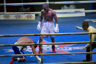 Cuban boxer Roniel Iglesias, center, looks to U.S. boxer Gabriel Maestre after knocking him down in their men's 69 kg boxing match in Havana, Cuba, Friday, April. 4, 2014. Boxers from the U.S. and Cuba went glove-to-glove on Cuban soil for the first time in 27 years Friday in a semipro World Series of Boxing clash (AP Photo/Ramon Espinosa)