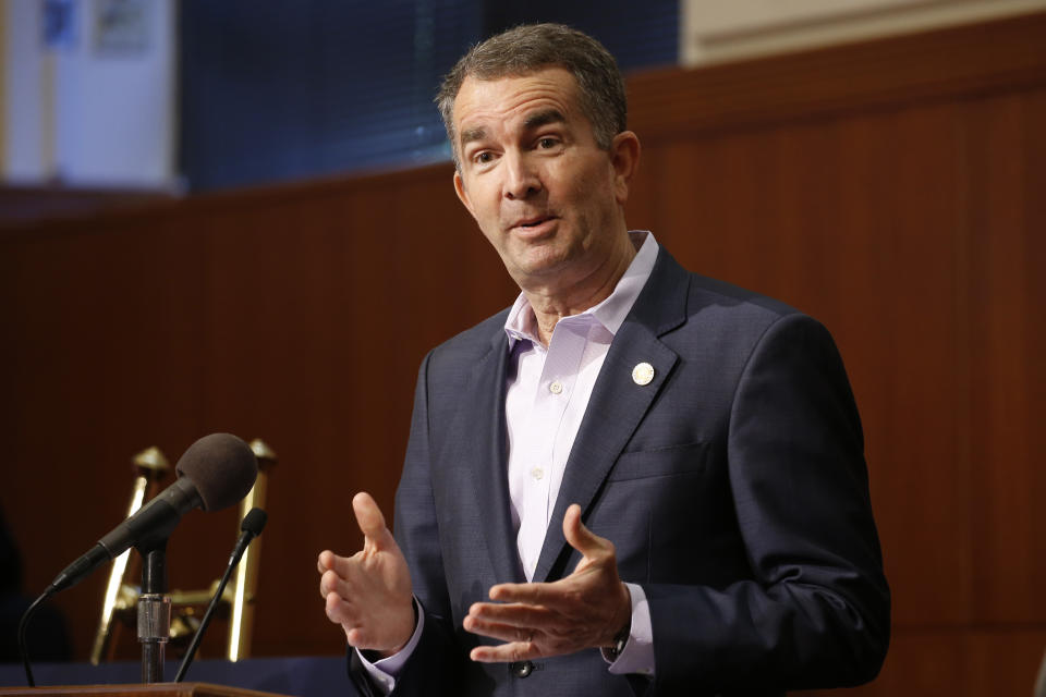 FILE - In this April 8, 2020 file photo, Virginia Gov. Ralph Northam gestures during a news conference at the Capitol in Richmond, Va. Gov. Northam announced Friday, April 10 that he'd signed bills that include requiring universal background checks on gun purchases, a red flag bill to allow authorities to temporarily take guns away from people deemed to be dangerous to themselves or others, and legislation giving local governments more authority to ban guns in public places. (AP Photo/Steve Helber, File)