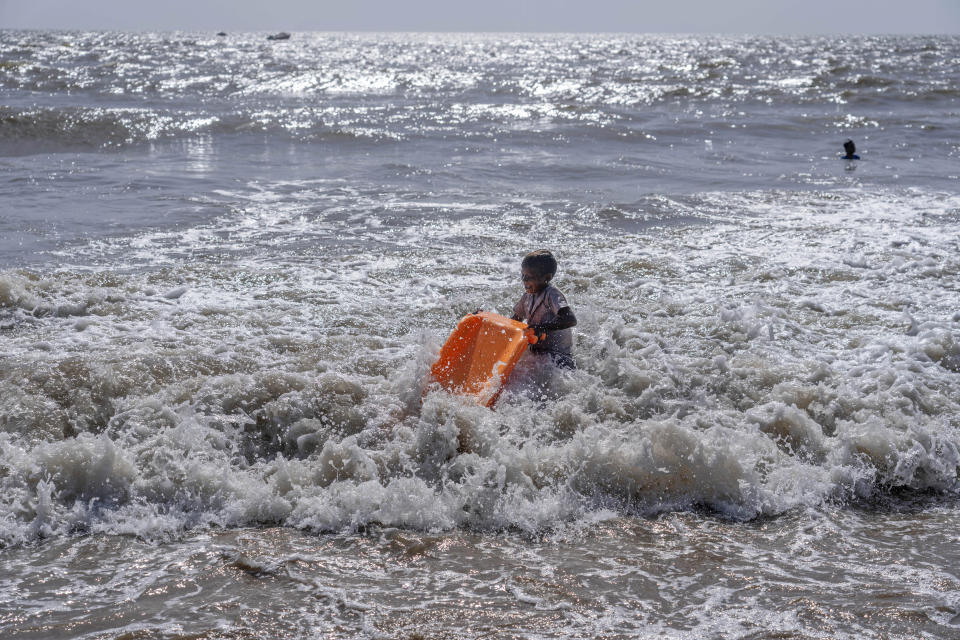 A boy plays in the Arabian Sea on a hot summer day in Mumbai, India, Thursday, May 2, 2024. (AP Photo/Rafiq Maqbool)