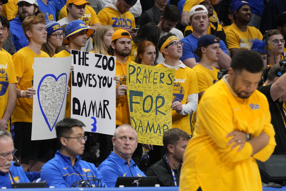 Pittsburgh head coach Jeff Capel, right, pauses during a timeout salute to former University of Pittsburgh football player Damar Hamlin, during the first half of an NCAA college basketball game against Virginia in Pittsburgh, Tuesday, Jan. 3, 2023. (AP Photo/Gene J. Puskar)