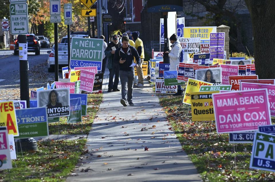 A voter walks along campaign signs nearby a polling station on Nov. 8, 2022, in Frederick, Maryland. <a href="https://media.gettyimages.com/id/1244628583/photo/a-voter-walks-down-a-sidewalk-lined.jpg?s=1024x1024&w=gi&k=20&c=Qse_OtCb8xrc4j5K33IUzR_MTbhLnR9O0VMwYLBnAms=" rel="nofollow noopener" target="_blank" data-ylk="slk:Ricky Carioti/The Washington Post via Getty Images;elm:context_link;itc:0;sec:content-canvas" class="link ">Ricky Carioti/The Washington Post via Getty Images</a>