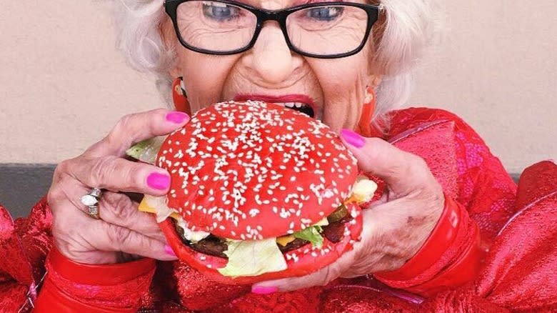 Woman taking bite of Angriest Whopper