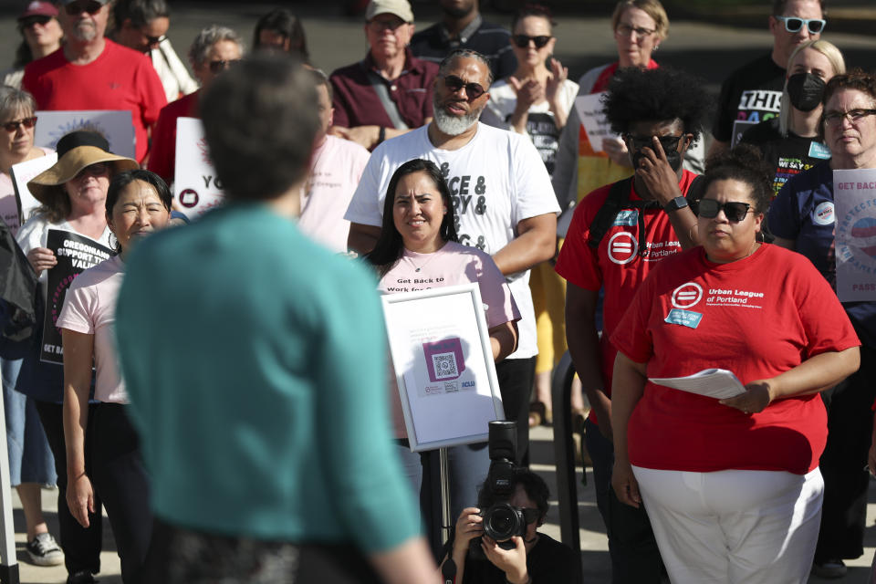 Attendees listen to a speech by Democratic Sen. Elizabeth Steiner during a rally calling for an end to the Senate Republican walkout at the Oregon State Capitol in Salem, Ore., Thursday, May 11, 2023. (AP Photo/Amanda Loman)