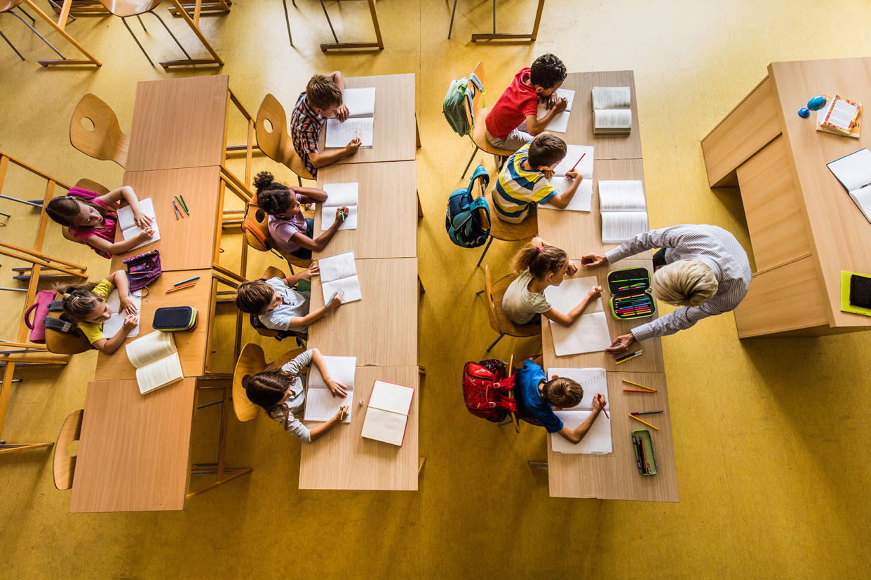 Above view of a class at elementary school Getty Images/skynesher