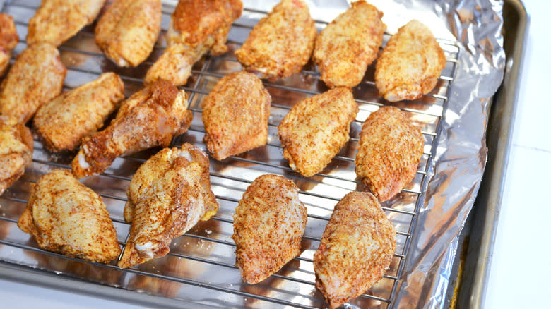 Seasoned chicken wings on baking tray