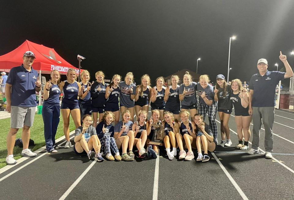 The Marysville girls track & field team celebrate after winning a Division 2 regional championship at Frankenmuth High School on Friday, May 20, 2022.