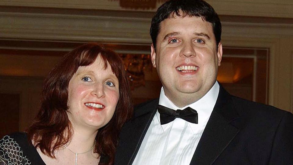 Peter Kay in a tuxe and wife Susan in a black patterned dress