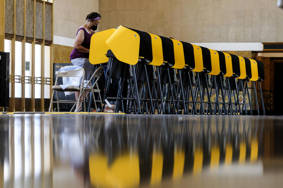 A voter casts a ballot for the California recall election at a vote center at Union Station, Tuesday, Sept. 14, 2021, in Los Angeles. (AP Photo/Ringo H.W. Chiu)