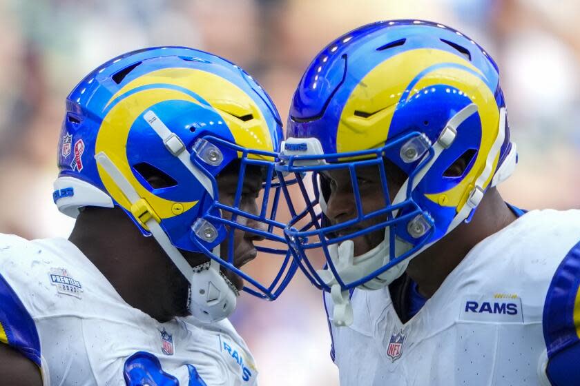 Los Angeles Rams defensive tackle Kobie Turner and defensive tackle Aaron Donald celebrates.