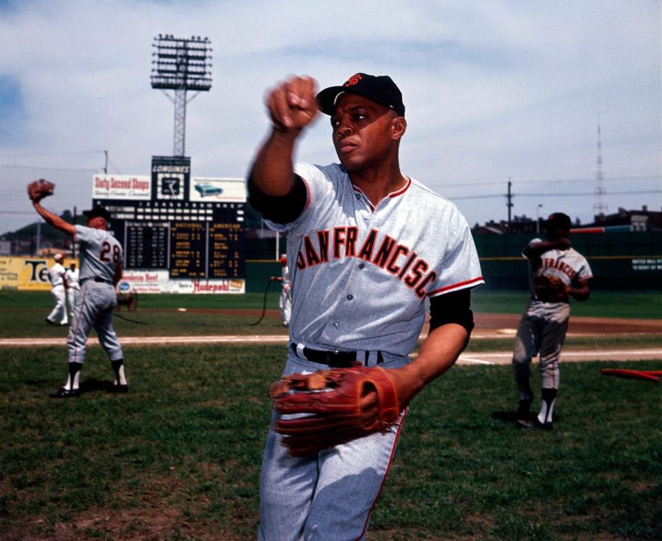 San Francisco Giants center fielder Willie Mays plays catch on the field.