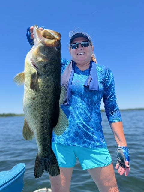 Jena Radley holds up this behemoth 10lb largemouth bass she caught while fishing with Capt. Paul Tyre.