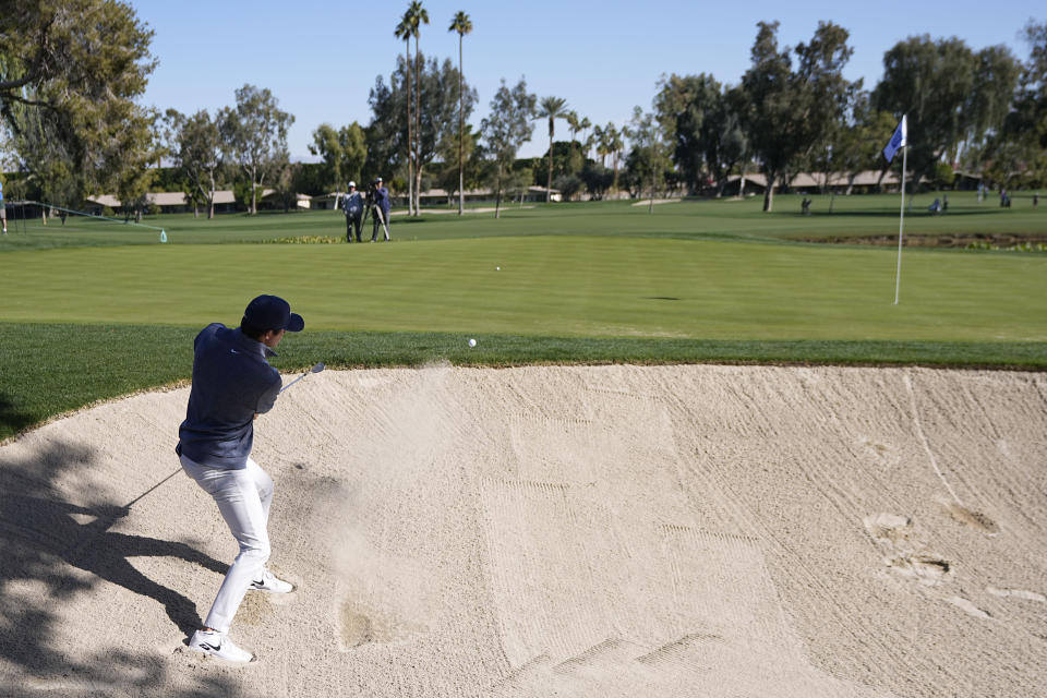 Davis Thompson hits from the bunker to the 12th green during the American Express golf tournament on the La Quinta Country Club Course Thursday, Jan. 19, 2023, in La Quinta, Calif. (AP Photo/Mark J. Terrill)