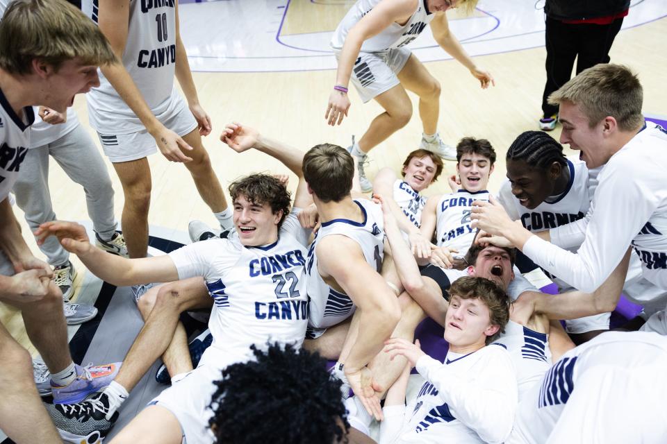 Corner Canyon celebrates after winning the 6A boys basketball finals at the Dee Events Center at Weber State in Ogden on Mar. 4, 2023.