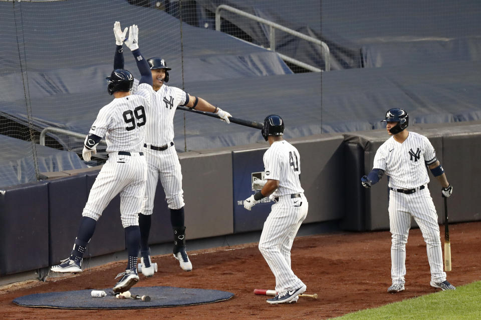 New York Yankees' Aaron Judge (99) celebrates with designated hitter and on-deck batter Giancarlo Stanton after hitting a three-run home run during the second inning of the team's baseball game against the Boston Red Sox, Sunday, Aug. 2, 2020, at Yankee Stadium in New York. (AP Photo/Kathy Willens)