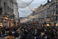 FILE - In this Saturday, Dec. 12, 2020 file photo crowds of shoppers walk under the Christmas lights in Regent Street, in London. (AP Photo/Alberto Pezzali, File)