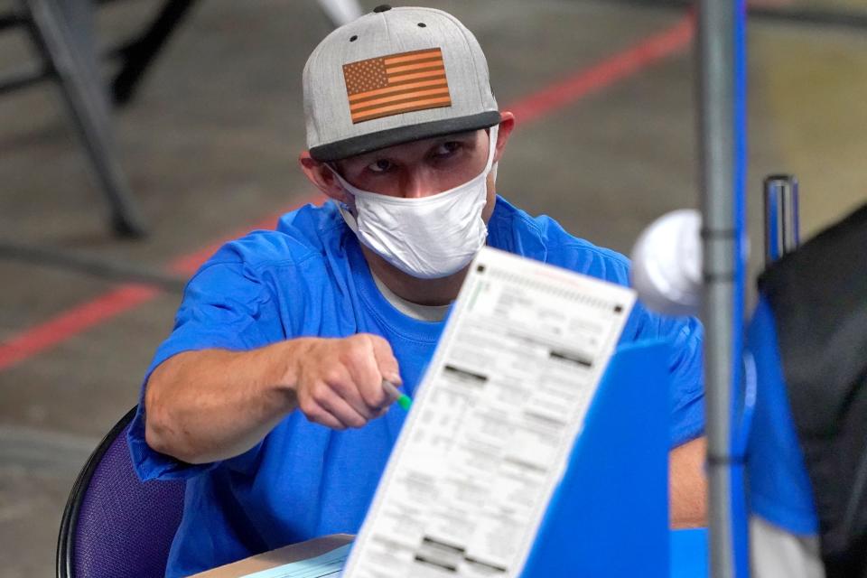 Maricopa County ballots cast in the 2020 general election are examined and recounted by contractors working for Florida-based company Cyber Ninjas in this May photo in Phoenix.