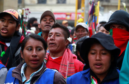 Indigenous Colombians rally for an imminent resolution to the nation’s peace agreement during a march with white flowers in Bogota, Colombia, October 12, 2016. REUTERS/John Vizcaino